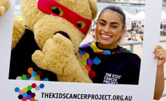 Volunteer with The Kids' Cancer Project Bear at an event supporting cancer fundraising