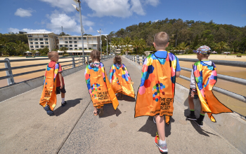 Children undertaking community fundraising with a The Kids' Cancer Project cape