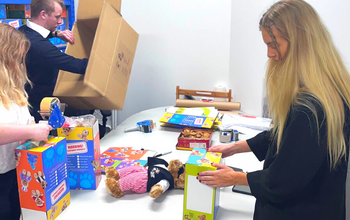 Volunteers packing fundraising bears. Supporting cancer fundraising efforts.