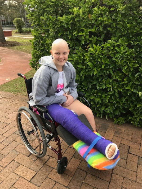 Molly in a wheelchair during her cancer treatment