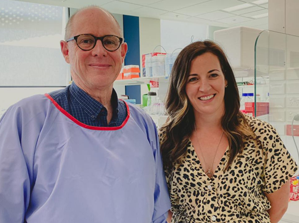 Professor Richard D'Andrea and a colleague smile for the camera in a research lab.