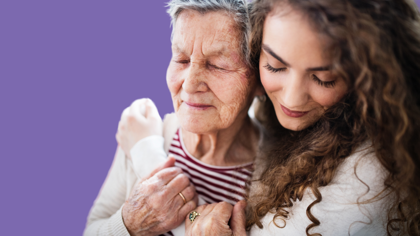 Grandmother and grandaughter embracing.