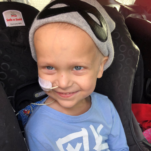 Ollie in a car seat undergoing treatment