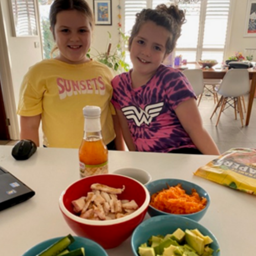 Kate's daughters are excitedly sitting at the kitchen bench with a healthy afternoon snack in front of them.