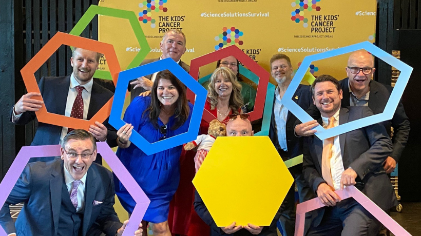 Sirron Holdings, Taren Cleaning Supplies and TKCP celebrate their multi-year partnership by posing energetically with colourful hexagonal shapes.