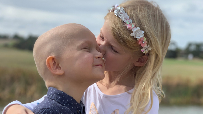 Ollie getting a kiss from his big sister