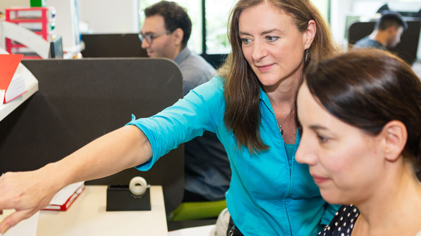 Michelle Henderson pointing out features with another researcher