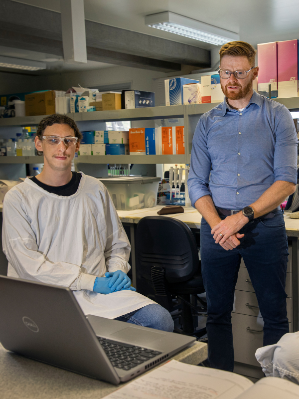 Childhood cancer researchers in their laboratory examining cancer research results on their computer