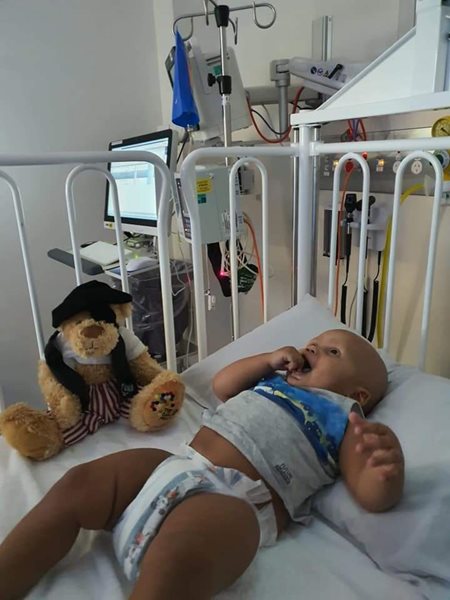 A TKCP pirate bear keeps CJ company as he lies on a small hospital bed, receiving treatment.