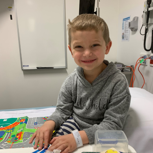 Ollie in the hospital with a big smile on his face
