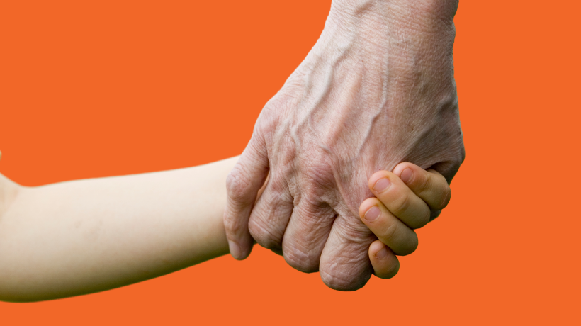 Holding hands - a childs hand in an older male hand